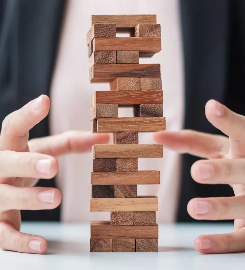 businesswoman-hand-cover-wooden-block-on-the-tower-2023-11-27-05-15-25-utc